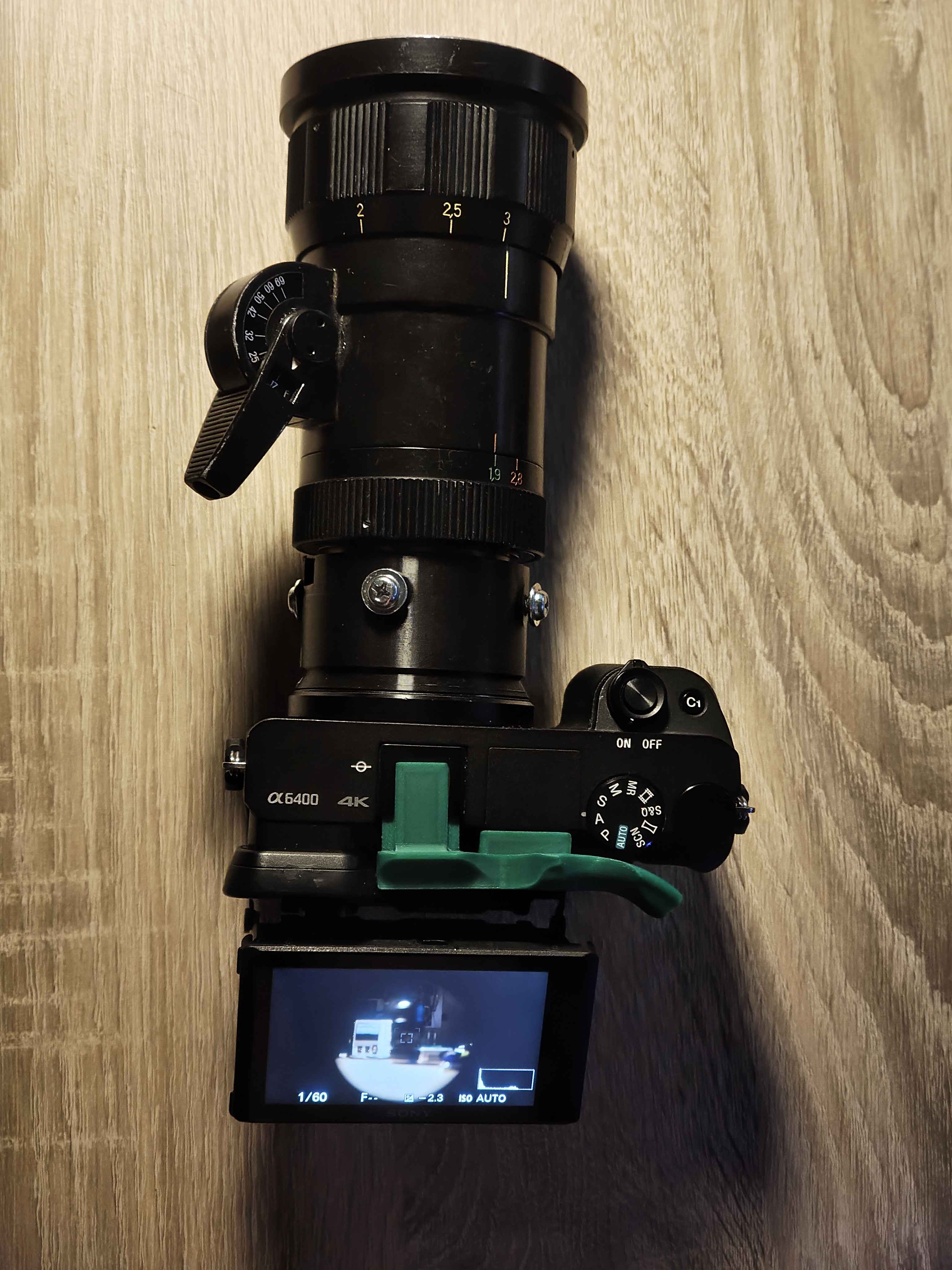 an image of a camera with an adapter and the lens.