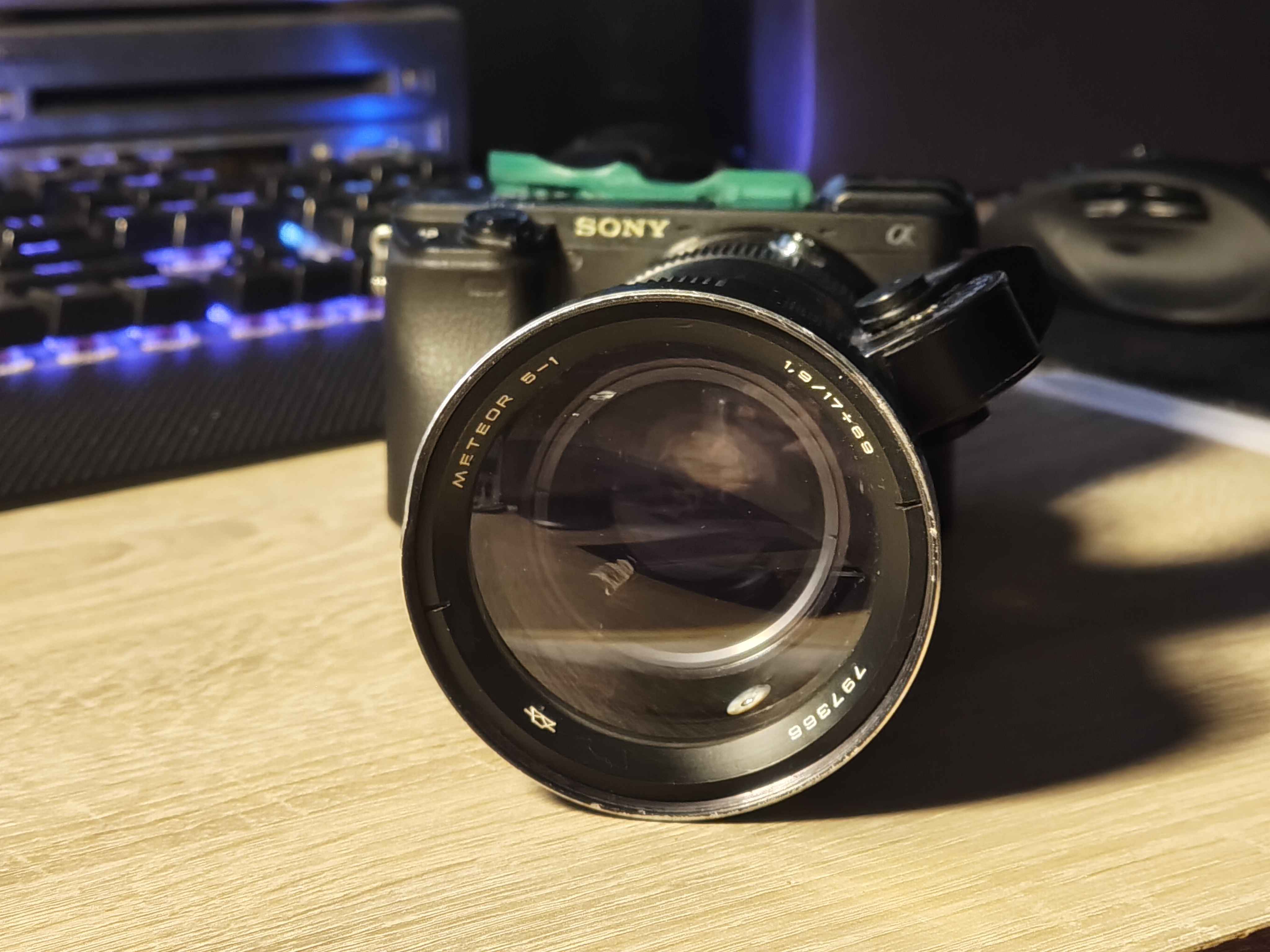 an image of a camera with an adapter and the lens.